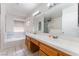 Bright bathroom with a double sink vanity, a large mirror, and a soaking tub at 4335 Twin Peaks Dr, North Las Vegas, NV 89032
