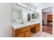 Bright bathroom featuring a double sink vanity and neutral tile flooring at 4335 Twin Peaks Dr, North Las Vegas, NV 89032