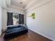 Cozy bedroom featuring wood floors and a view of the outside at 4335 Twin Peaks Dr, North Las Vegas, NV 89032