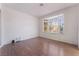 A bedroom with wood floors and a large window provides natural light at 4335 Twin Peaks Dr, North Las Vegas, NV 89032