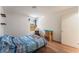 Bedroom with hardwood floors, a window, and a bed with blue striped bedding at 4335 Twin Peaks Dr, North Las Vegas, NV 89032