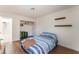 Cozy bedroom featuring wood-look floors, built-in closet, and natural light at 4335 Twin Peaks Dr, North Las Vegas, NV 89032