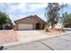 A single-story home featuring a two-car garage, a clean driveway, and desert landscaping at 4335 Twin Peaks Dr, North Las Vegas, NV 89032