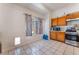 Kitchen with a window, stainless steel appliances, tile floors, and wooden cabinets at 4335 Twin Peaks Dr, North Las Vegas, NV 89032
