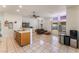 Open kitchen with a breakfast bar, tile flooring, and an adjacent seating area at 4335 Twin Peaks Dr, North Las Vegas, NV 89032