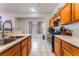 Kitchen with a breakfast bar, stainless steel appliances, tile floors, and wooden cabinets at 4335 Twin Peaks Dr, North Las Vegas, NV 89032