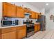 The kitchen features stainless steel appliances, tile floors, and wooden cabinets at 4335 Twin Peaks Dr, North Las Vegas, NV 89032