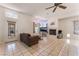 Spacious living room with a cozy fireplace, tiled floors, and backyard access at 4335 Twin Peaks Dr, North Las Vegas, NV 89032