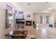 Bright living room with fireplace, tiled floors, multiple windows, and neutral colors at 4335 Twin Peaks Dr, North Las Vegas, NV 89032