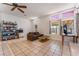 Bright living room with tile flooring, a ceiling fan, and natural light from multiple windows at 4335 Twin Peaks Dr, North Las Vegas, NV 89032