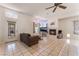 Spacious living room with a cozy fireplace, tiled floors, and backyard access at 4335 Twin Peaks Dr, North Las Vegas, NV 89032