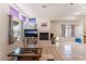 Bright living room with fireplace, tiled floors, multiple windows, and neutral colors at 4335 Twin Peaks Dr, North Las Vegas, NV 89032
