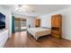 Main bedroom with wood flooring, private backyard access, and wooden cabinets at 4335 Twin Peaks Dr, North Las Vegas, NV 89032