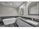 Modern bathroom featuring dual sinks, sleek countertops, and a luxurious bathtub at 4525 Dean Martin Dr # 2903, Las Vegas, NV 89103