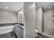 Modern bathroom featuring dual sinks, a luxurious bathtub, and a glass-enclosed shower at 4525 Dean Martin Dr # 2903, Las Vegas, NV 89103