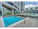 Modern condo with a shimmering blue hot tub, lounge chairs and a modern glass building in the background at 4525 Dean Martin Dr # 2903, Las Vegas, NV 89103
