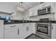 Modern kitchen with stainless steel appliances, black countertops, and white cabinetry at 4525 Dean Martin Dr # 2903, Las Vegas, NV 89103