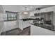 Modern kitchen with white cabinets, black countertop island, and stainless appliances, adjacent to living area at 4525 Dean Martin Dr # 2903, Las Vegas, NV 89103