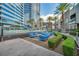 Upscale pool area with contemporary blue lounge seating, palm trees, and modern landscaping at 4525 Dean Martin Dr # 2903, Las Vegas, NV 89103
