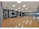 Bright yoga studio with mirrors, hardwood floors, and wall-mounted TVs at 4525 Dean Martin Dr # 2903, Las Vegas, NV 89103