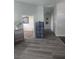 Bright hallway featuring open doors, hard surface flooring, storage, and ample access to the home at 4764 Wild Draw Dr, North Las Vegas, NV 89031