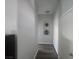 Clean hallway with neutral walls, hard surface flooring, decorative niche, and closet space at 4764 Wild Draw Dr, North Las Vegas, NV 89031