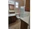 Well lit bathroom featuring a toilet, sink, cabinets, and glass shower doors at 5110 Silenzio St, Las Vegas, NV 89135