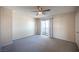 Spacious bedroom with a sliding door, neutral carpet, and ceiling fan at 5241 Janfred Ct # 18, Las Vegas, NV 89103