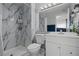 Bathroom featuring a modern vanity, toilet, and a marble-tiled shower stall at 5375 Chestnut St, Las Vegas, NV 89119