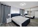 This bedroom features a bed with upholstered headboard, mirrored closet, and decorative crystal chandelier at 5375 Chestnut St, Las Vegas, NV 89119