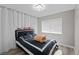 This bedroom features luxury vinyl floors, a window, and a decorative crystal chandelier at 5375 Chestnut St, Las Vegas, NV 89119