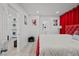Bright bedroom boasts a large bed, unique artwork, and a doorway to a laundry area at 5375 Chestnut St, Las Vegas, NV 89119