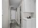 Hallway with wood flooring, storage cabinets, and doors at 5375 Chestnut St, Las Vegas, NV 89119