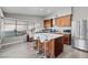Stylish kitchen boasts wood cabinets, stainless appliances, and a center island with seating at 5375 Chestnut St, Las Vegas, NV 89119