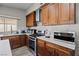 Modern kitchen features stainless steel appliances, white countertops, wooden cabinets, and natural light at 5375 Chestnut St, Las Vegas, NV 89119