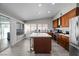 Bright kitchen featuring wood cabinets, stainless appliances, and an island with countertop seating at 5375 Chestnut St, Las Vegas, NV 89119