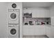 Well-lit kitchen features white cabinets, modern appliances, and in-unit washer and dryer at 5375 Chestnut St, Las Vegas, NV 89119
