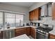 Bright kitchen boasts stainless steel appliances, white countertops, wooden cabinets, and modern fixtures at 5375 Chestnut St, Las Vegas, NV 89119