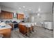 Kitchen with stainless steel appliances, white countertops, wooden cabinets, and island with barstool seating at 5375 Chestnut St, Las Vegas, NV 89119