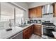 Well-lit kitchen boasts stainless steel appliances, white countertops, wooden cabinets, and modern fixtures at 5375 Chestnut St, Las Vegas, NV 89119