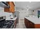 Well-equipped kitchen featuring stainless steel appliances, white countertops, wooden cabinets, and modern fixtures at 5375 Chestnut St, Las Vegas, NV 89119
