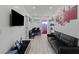 Modern living room features a sleek sofa, mounted TV, and an open dining area beyond at 5375 Chestnut St, Las Vegas, NV 89119