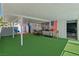 Large covered patio with artificial turf creates an inviting space for relaxation and entertainment at 5375 Chestnut St, Las Vegas, NV 89119