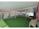 Spacious covered patio with artificial turf offers versatile space for recreation and relaxation at 5375 Chestnut St, Las Vegas, NV 89119