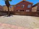 Large backyard featuring a paved patio, brick wall, and ample space for recreation at 5419 Brass Hills Ct, Las Vegas, NV 89122