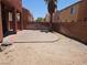 A spacious backyard featuring a custom stone patio and privacy wall ready for backyard entertaining at 5419 Brass Hills Ct, Las Vegas, NV 89122