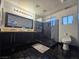 Modern bathroom featuring a glass shower, double vanity, and black tile flooring at 5419 Brass Hills Ct, Las Vegas, NV 89122