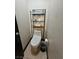 Efficient bathroom featuring a modern toilet and space-saving storage shelf at 5419 Brass Hills Ct, Las Vegas, NV 89122
