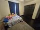 Bedroom with dark wood floors, neutral walls, a bed, and closet at 5419 Brass Hills Ct, Las Vegas, NV 89122