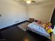 Bedroom with dark wood floors, neutral walls, a bed, nightstand, and rug at 5419 Brass Hills Ct, Las Vegas, NV 89122